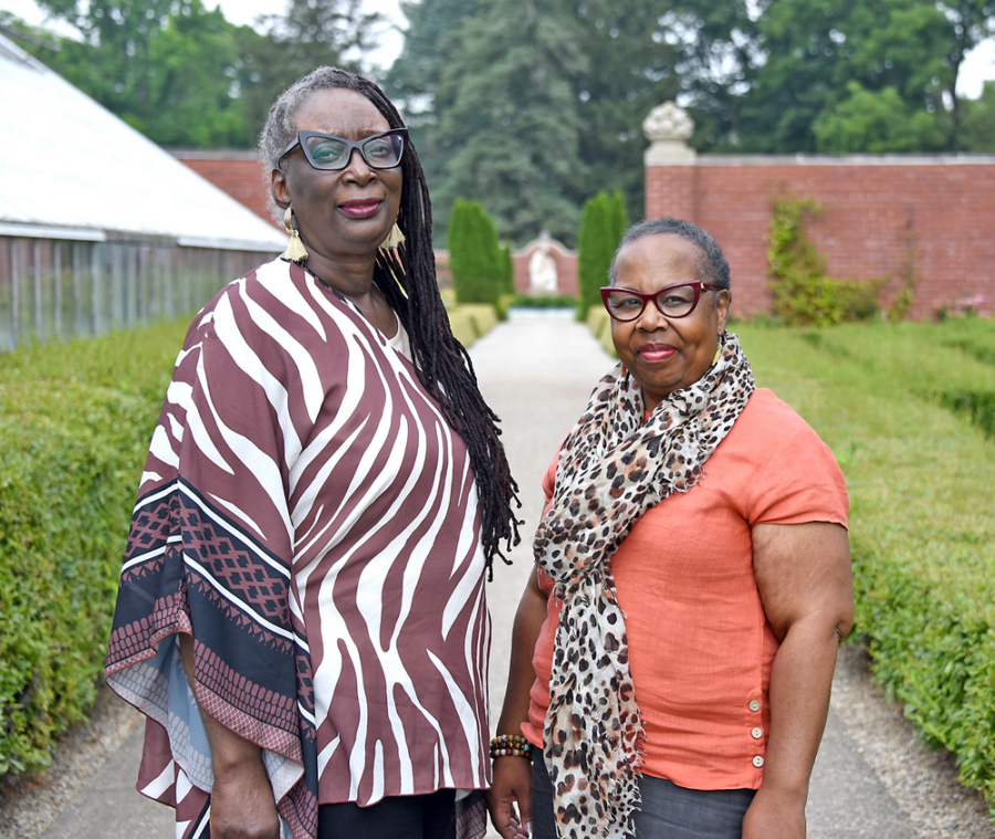 Sandra Jackson-Opoku and Tina Jenkins Bell standing on a path outside at Allerton.