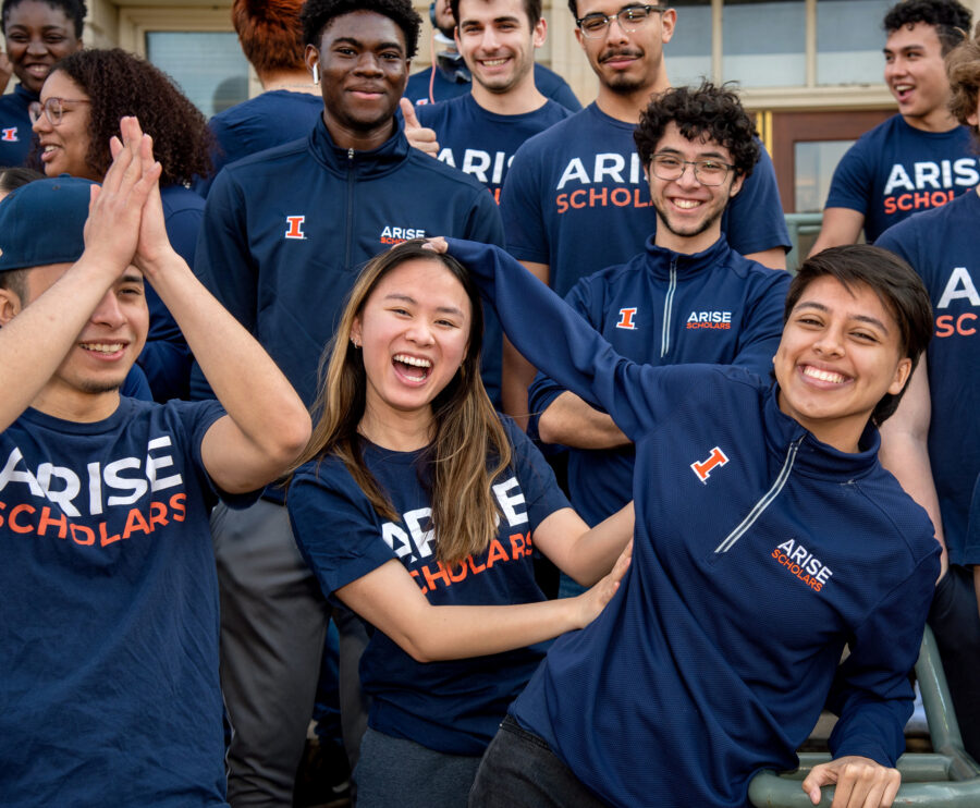 Students from ARISE smiling and posing playfully in their ARISE attire.