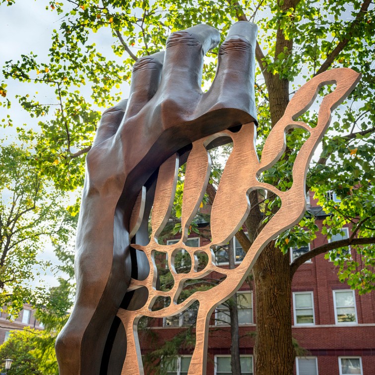 Sculpture of human hand with bone structure partially visible.