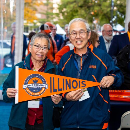 Posing for photo with Illinois pennant.